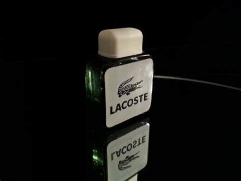 cologne with alligator on bottle.